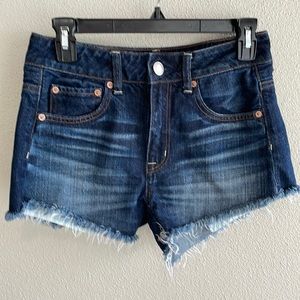 High Rise Festival Frayed denim shorts